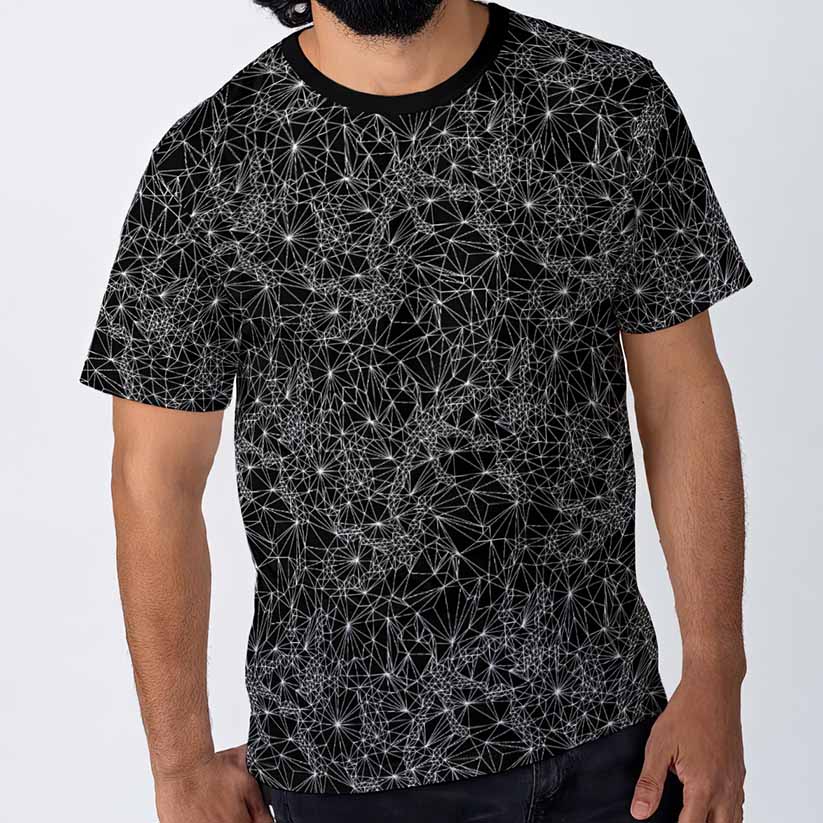 Person wearing a black t-shirt with geometric white pattern on a light gray background