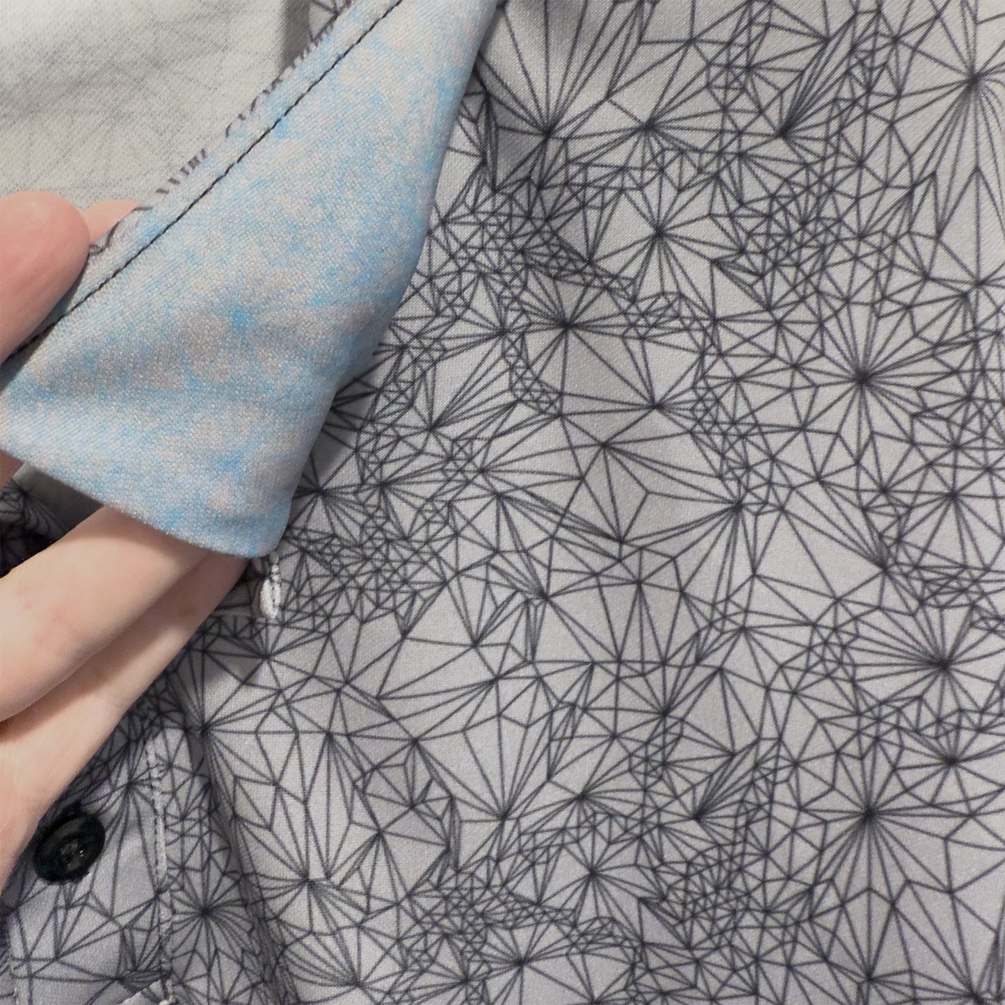 View of special hidden detail under collar of Tri-Geometric all over pattern Polo Golf Style Shirt