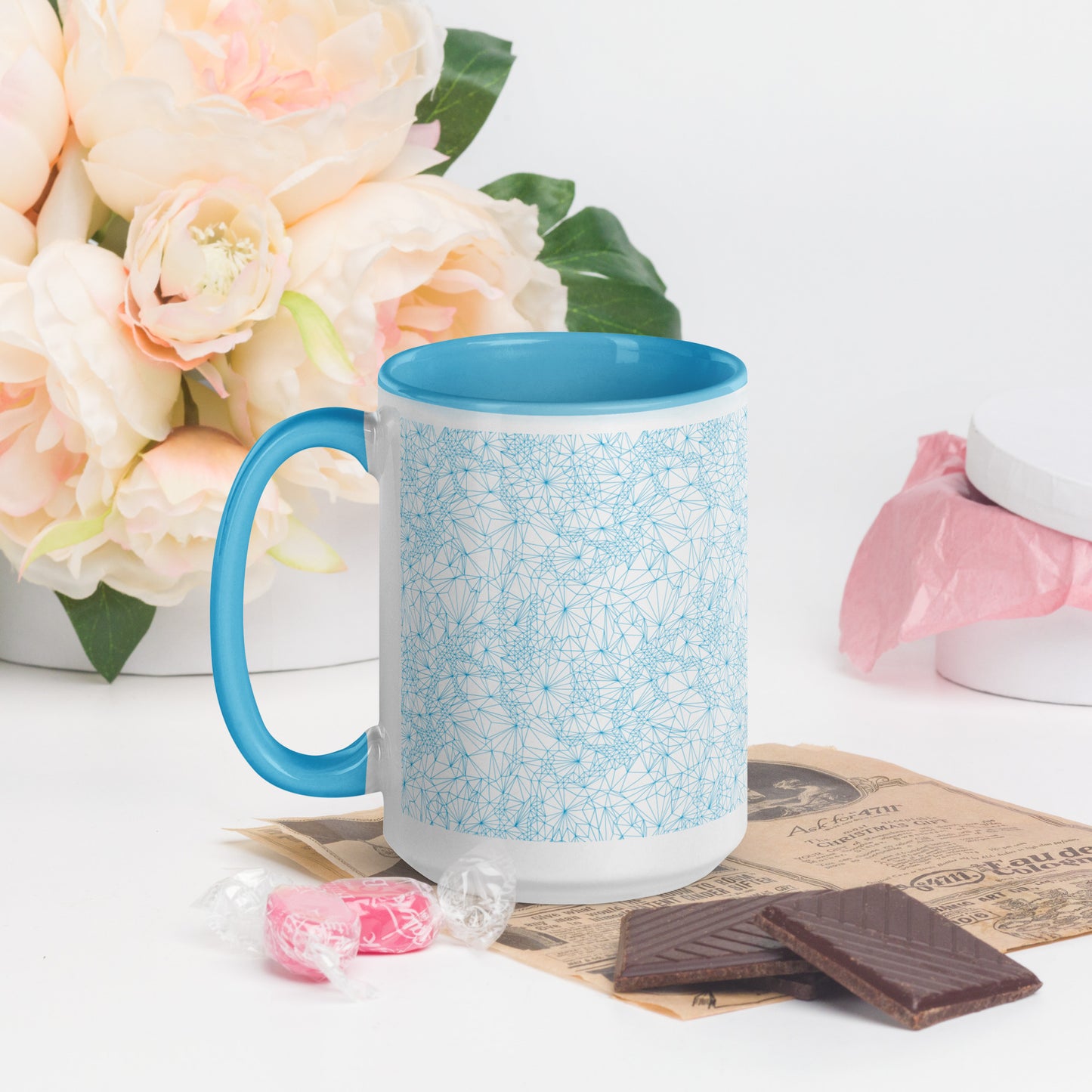 15 ounce Blue Tri-Mesh Geometric Mug with Blue Interior with chocolates and candies on a table