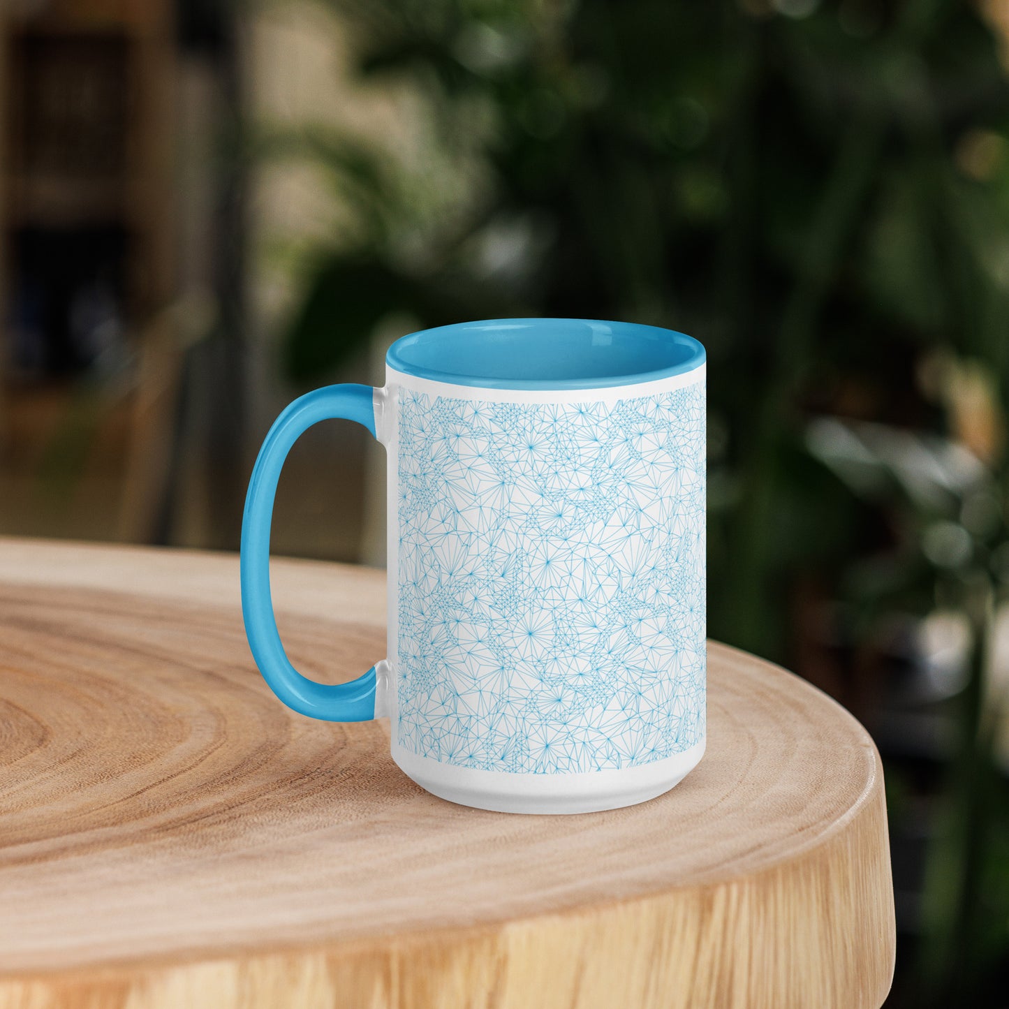 15 ounce Blue Tri-Mesh Geometric Mug with Blue Interior sitting on a wooden table