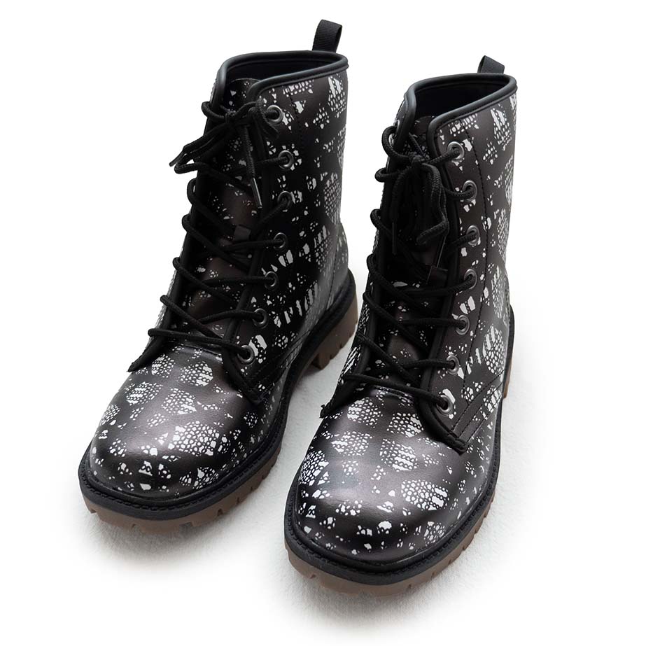 Black lace-up boots with black and white lace pattern on a white background