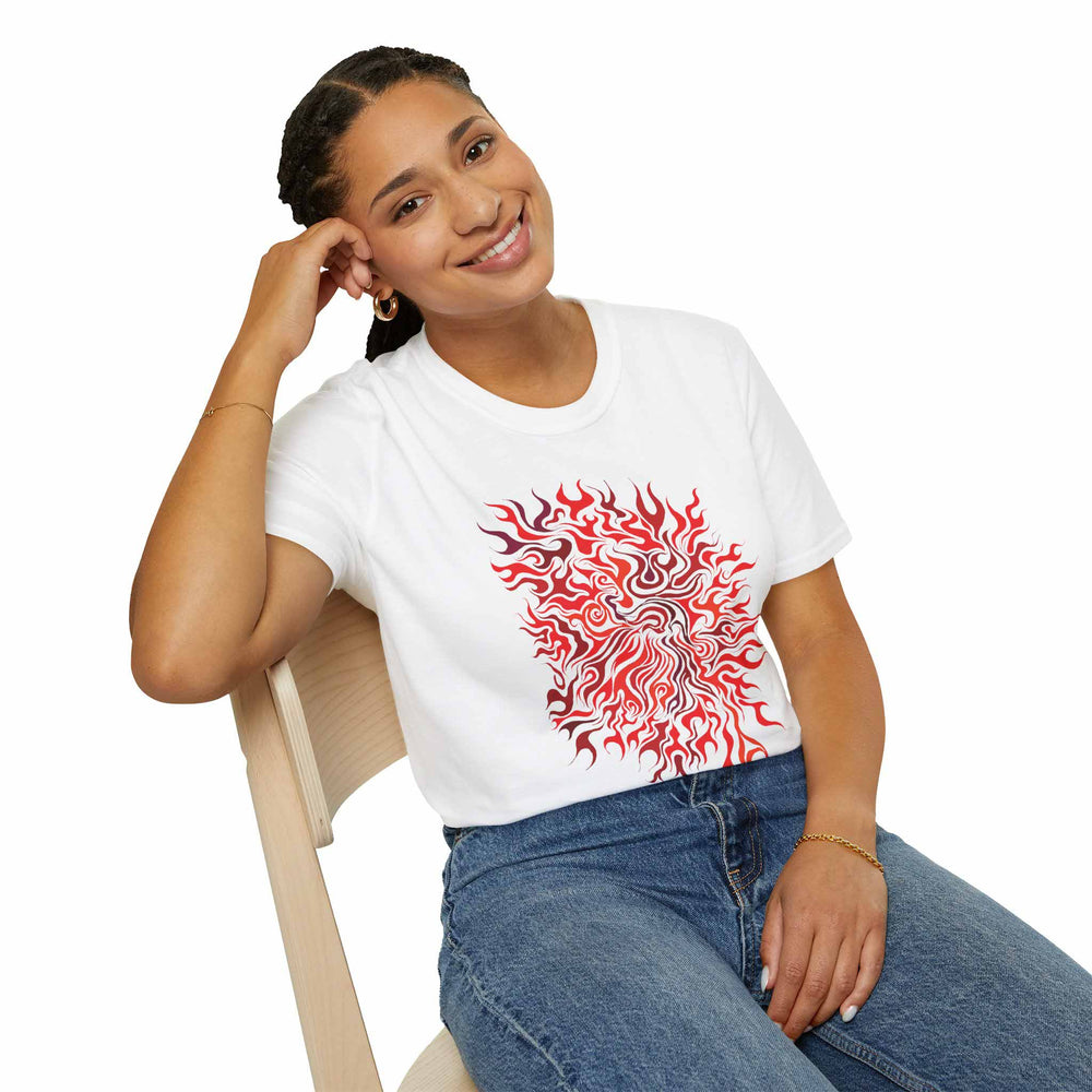 Woman wearing a white t-shirt with the vibrant red and orange print called Clarity, sitting on a chair against a white background