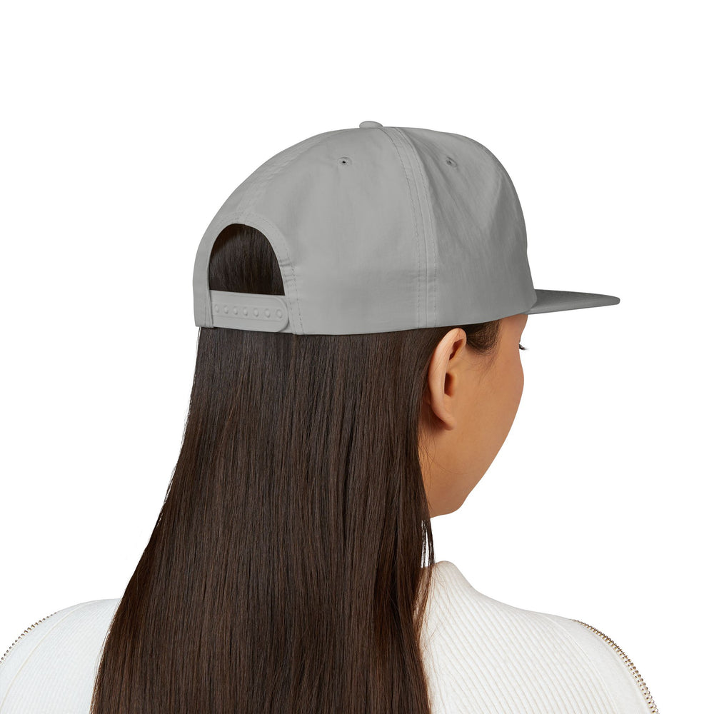 A woman wearing Eco-Conscious Recycled Nylon Surf Cap Hat with Digi Board Lines.
