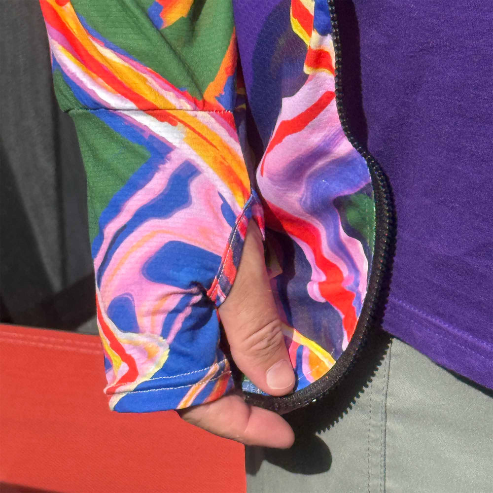 Thumb holes detail on colorful psychedelic abstract patterned sun protection hoodie on a white background