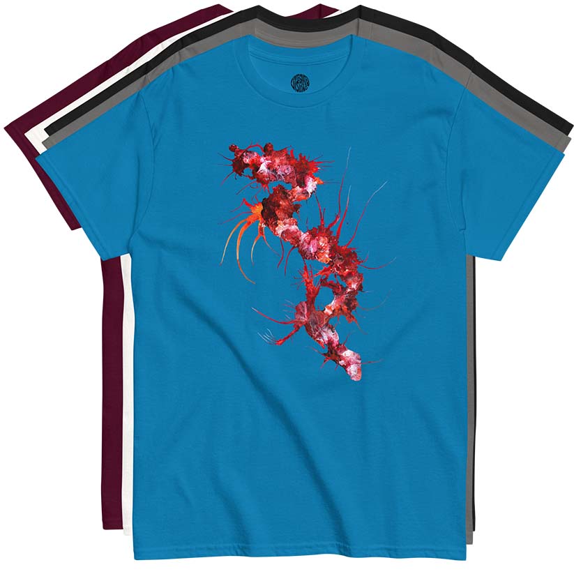 Blue t-shirt with a red and white painterly design stacked on top of a charcoal, black, white, and maroon shirt on a white background