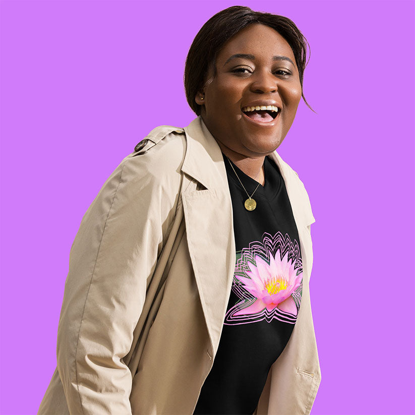 Person wearing a beige trench coat over a black t-shirt with a pink lotus flower design on a purple background