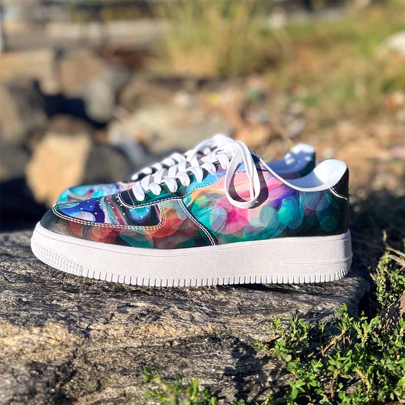 Colorful Abstract pattern sneakers sitting on a rock at Red Hook in Brooklyn, New York