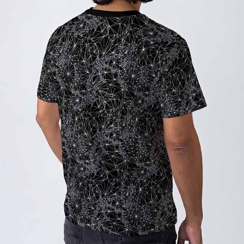 Person wearing a black t-shirt with white geometric pattern on a plain background