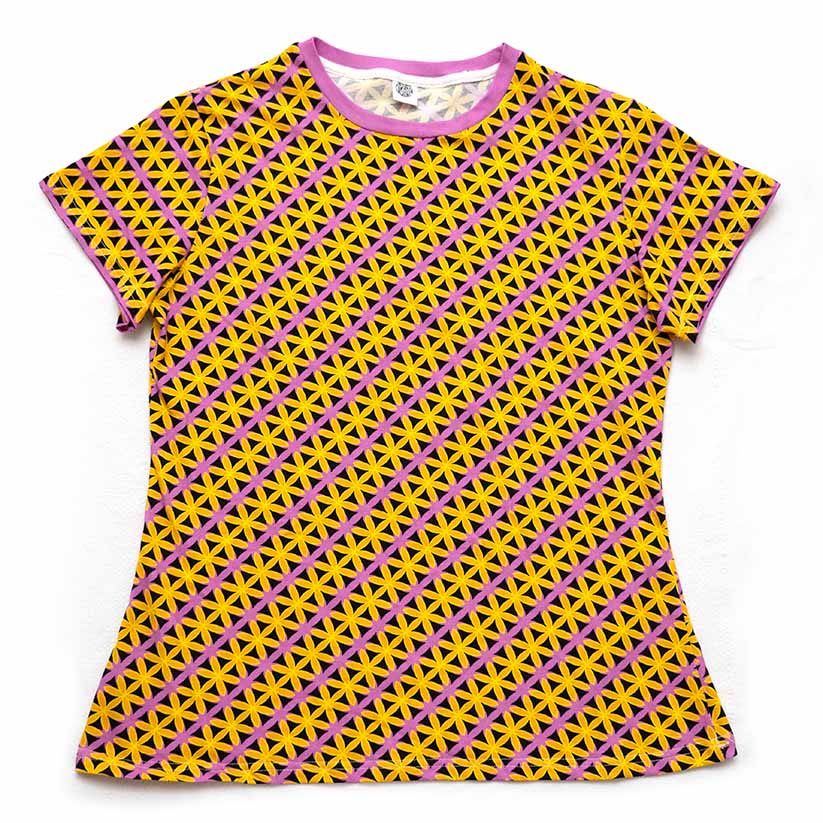 A short-sleeve crewneck t-shirt featuring a vibrant geometric pattern of yellow and pink petals, displayed flat against a white background.