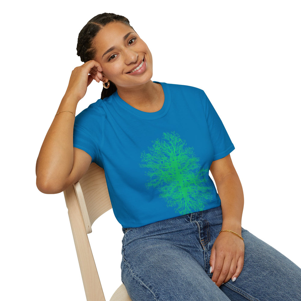 Person wearing a sapphire blue t-shirt with a green tree design, sitting on a chair against a white background