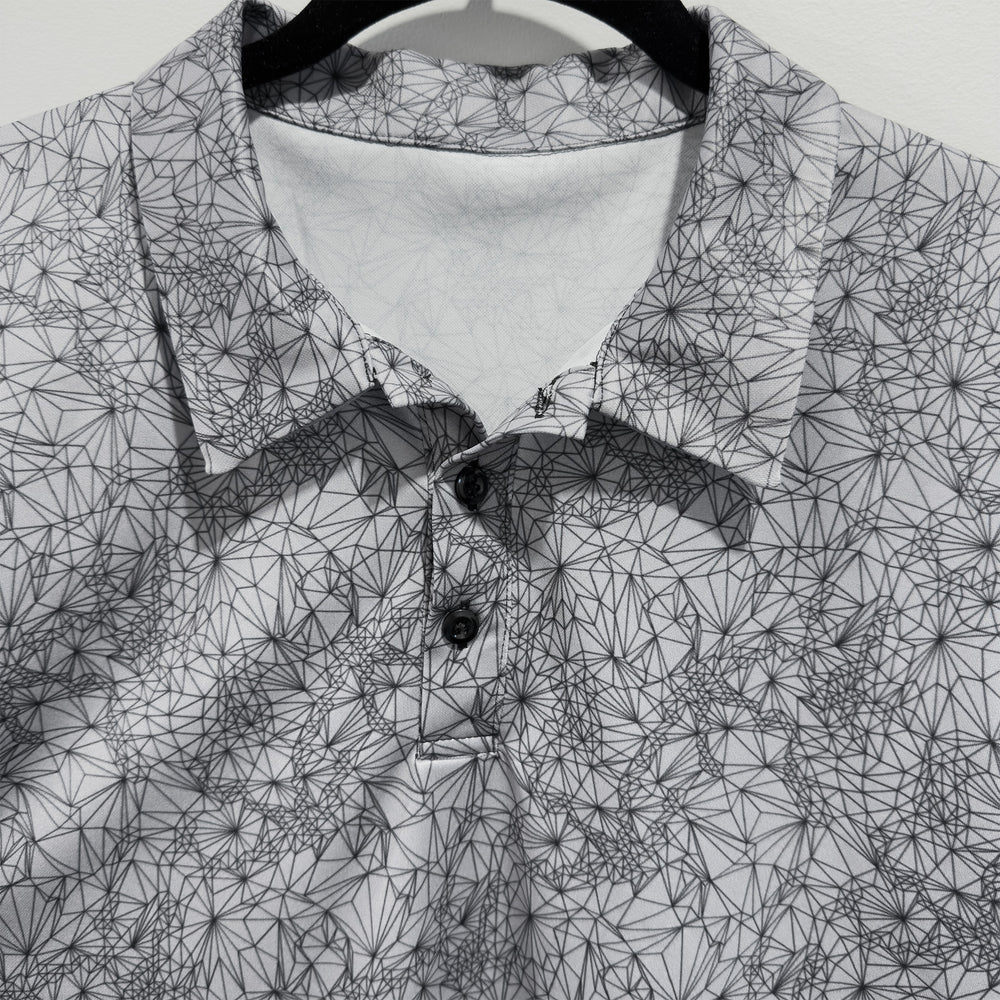 Detail of collar and buttons on Tri-Geometric all over pattern Golf Polo Style Shirt