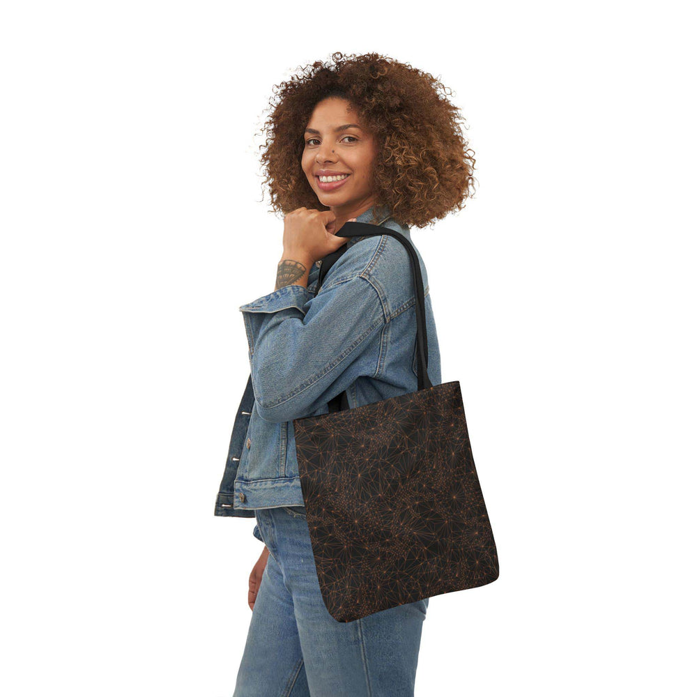 A woman holding the small 13x13 inch dark Tri-Mesh Geometric tote bag which includes a black inner lining and black handle.