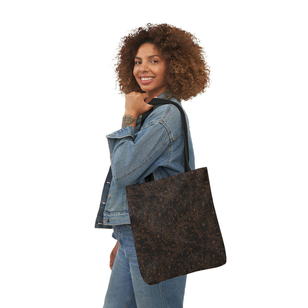 A woman holding the 16x16 inch version of the Tri-Mesh Geometric tote bag with an inner lining and black handle.