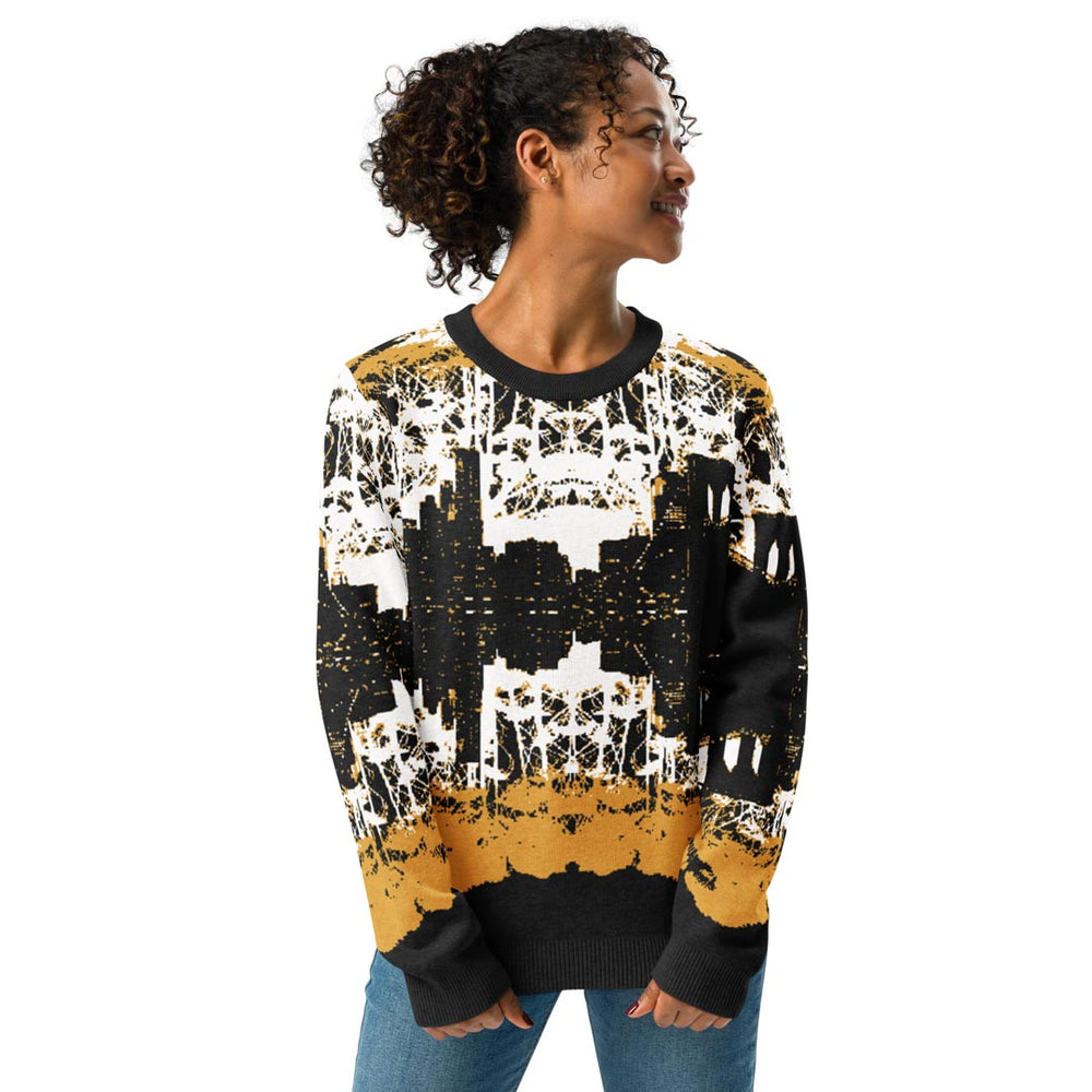 Woman wearing a black, white, and yellow patterned sweater on a white background