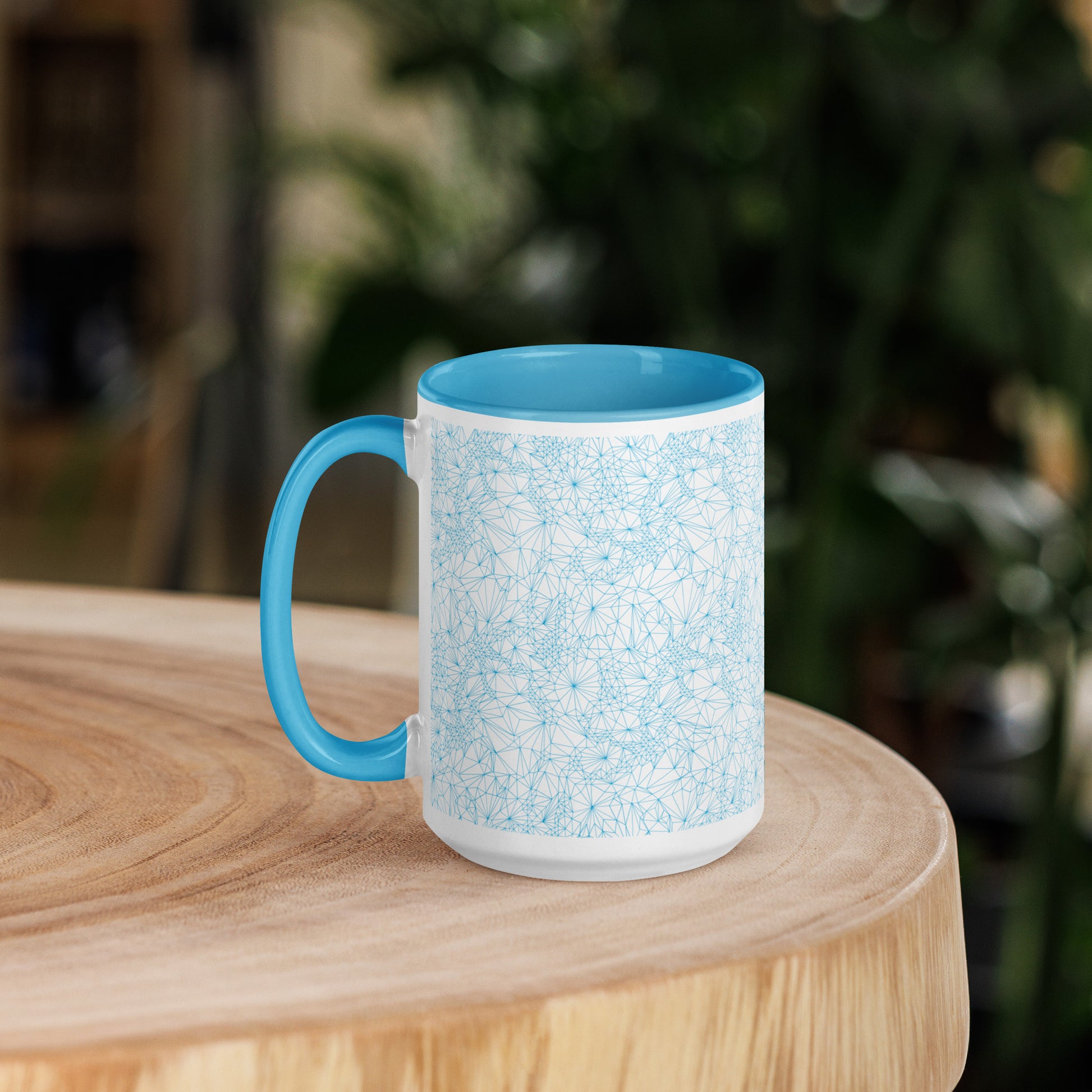 15 ounce Blue Tri-Mesh Geometric Mug with Blue Interior sitting on a wooden table